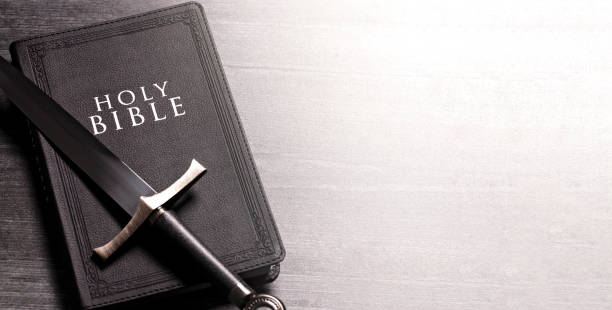 istock Bible and a Sword on a Dark Wooden Table 1303687304