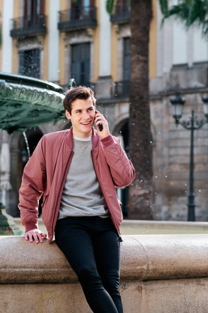 istock Young man talking on the phone outdoors. 1303687326