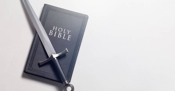 istock A Bible and Sword on a Bright White Background 1303687376