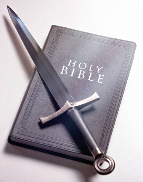 istock A Bible and Sword on a Bright White Background 1303687385