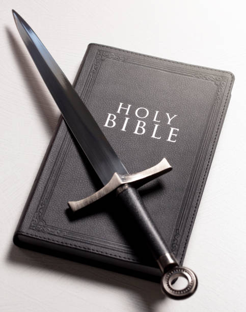 istock A Bible and Sword on a Bright White Background 1303687393