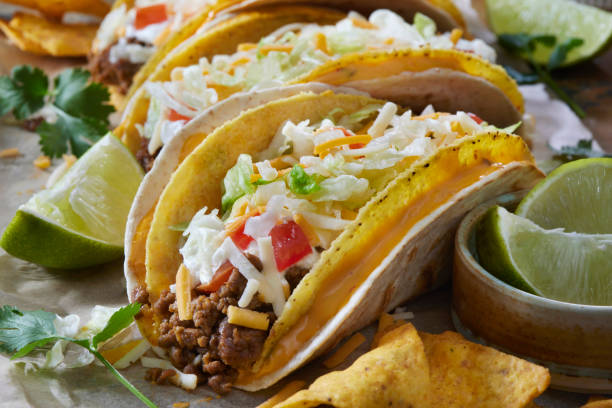 The Cheesy Gordita Beef Taco The home made Copycat Gordita: seasoned ground beef-filled crunchy taco shell with Ranch sauce, shredded lettuce, tomato and cheddar cheese, wrapped in a flour Tortilla cheese dip stock pictures, royalty-free photos & images