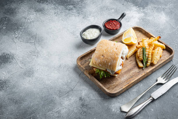istock homemade baguette with crumbed fish, on gray background , with copyspace  and space for text 1303688805