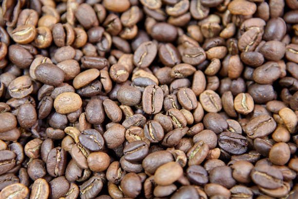istock Roasted coffee beans on counter in coffee shop. 1303689618