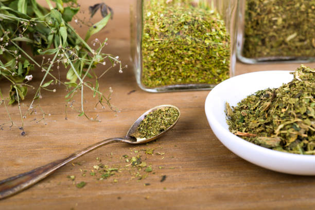 istock Herbal tea and dried herbs or medicine in jars with spoon 1303689714