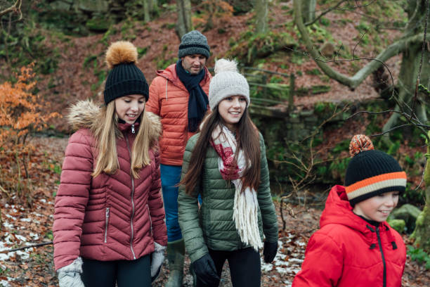 istock Father and His Children Walking Through the Woods 1303689832