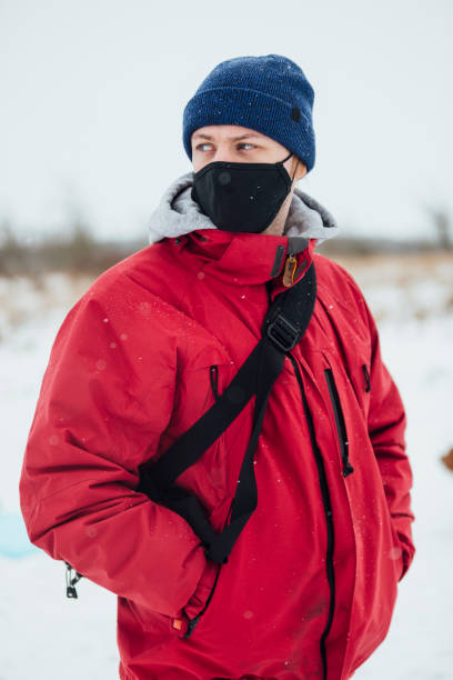 istock Young Man Wrapped Up in the Snow 1303689882