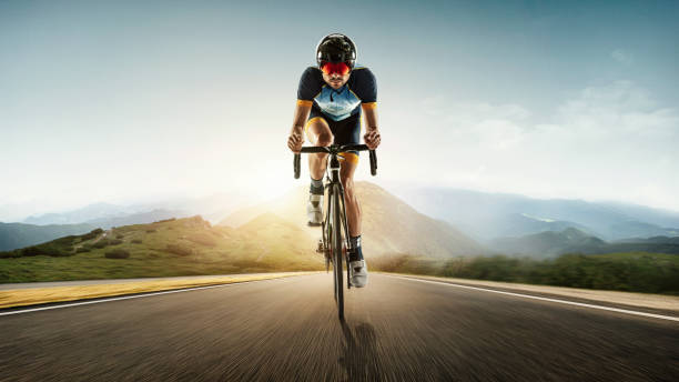 istock Triathlon male athlete training on meadow background. Caucasian fit triathlete practicing in cycling wearing sports equipment. 1303689989