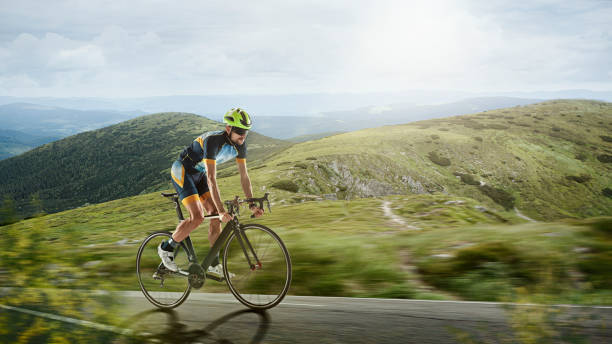 istock Triathlon male athlete training on mountains background. Caucasian fit triathlete practicing in cycling wearing sports equipment. 1303689996