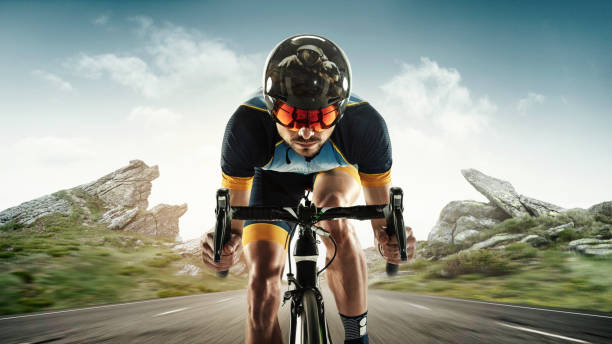 istock Triathlon male athlete training on mountains background. Caucasian fit triathlete practicing in cycling wearing sports equipment. 1303689998