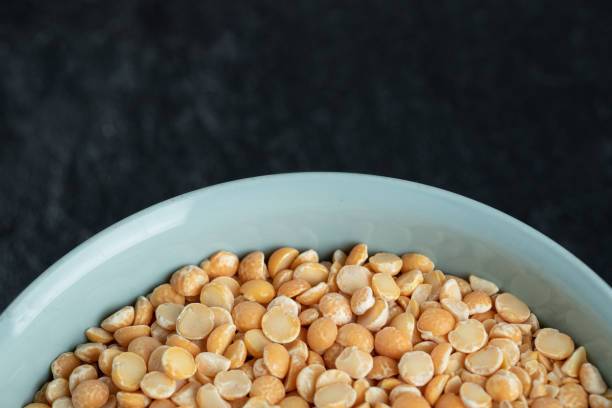 istock A blue plate with unprepared lentils in a dark background 1303690297