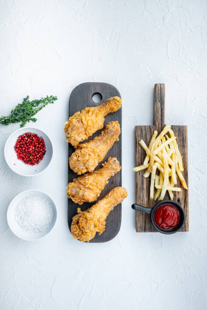 istock Crispy fried chicken leg on white background, flat lay 1303691327
