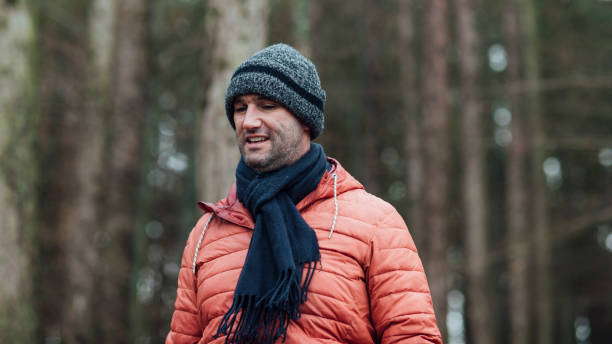istock Mature Man Walking Through the Forest 1303691337