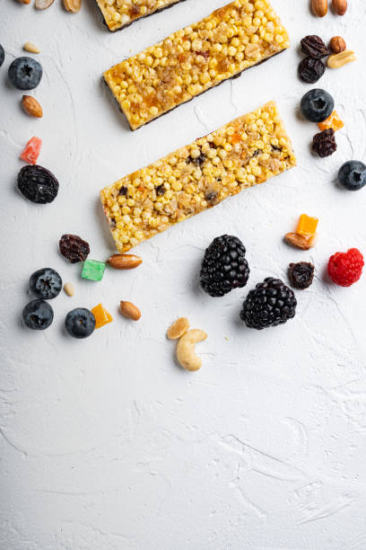 istock Raw organic granola bars with seeds and nuts, top view with copy space, on white background 1303691650