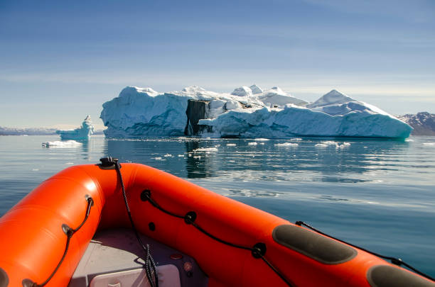 istock Bow of a dingy sailing among icebergs 1303691904