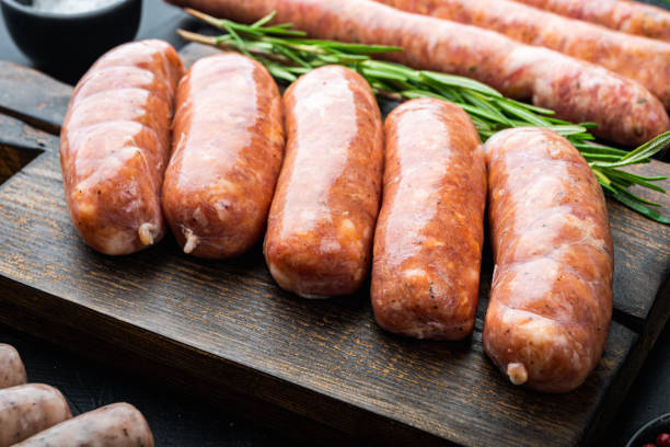 istock Traditional raw sausages, on black background 1303694334