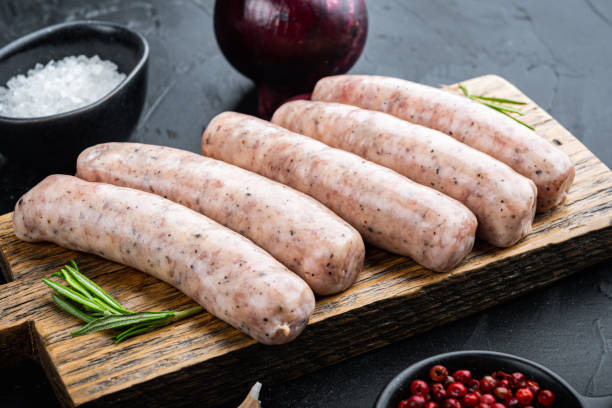istock Homemade chicken sausages, on black background 1303694629