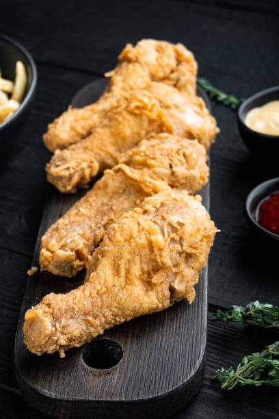 istock Crispy fried chicken on black wooden table 1303696812