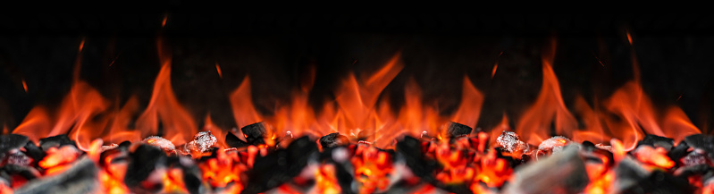 Flame through Barbecue Braai Grid at Night