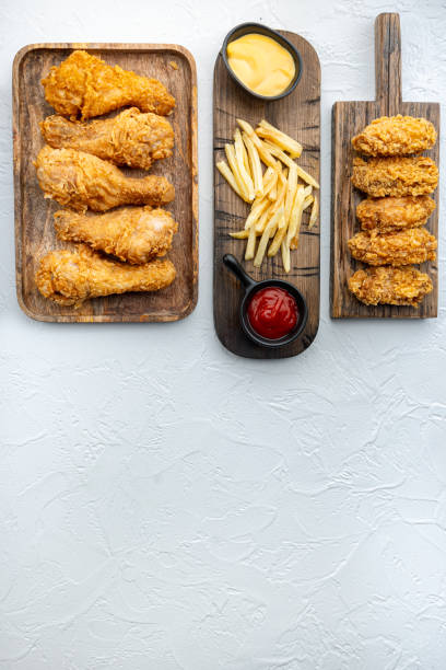 istock Homemade crispy fried chicken on white background, flat lay, with copy space 1303697157