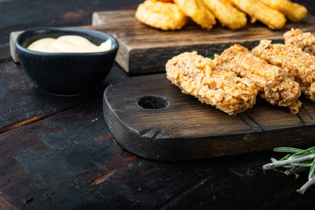 istock Fried chicken wings on old dark wooden table 1303697277