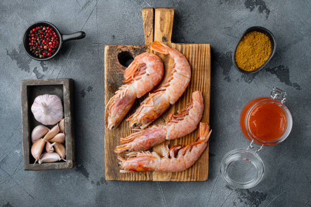 istock Raw barbeque grilling red Argentinian prawns ingredients, on gray background, top view flat lay 1303700075