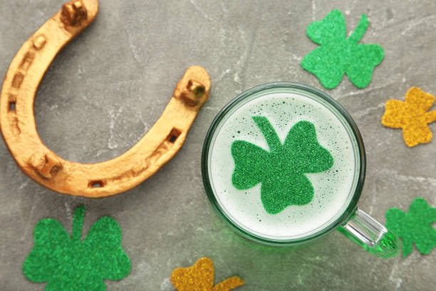 istock St. Patricks Day. Clover in Beer Mug on grey background with space for copy, text, your words. 1303701384