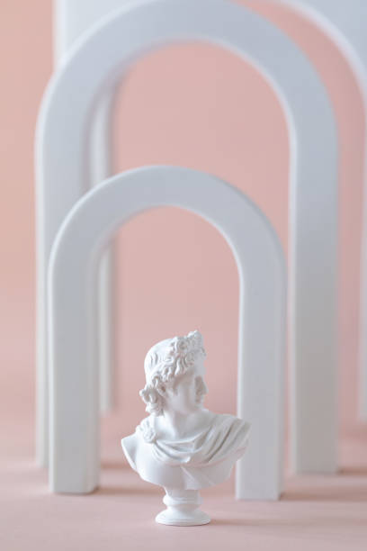 istock Antique statue of Apolon on a pink background 1303701423