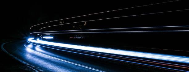 istock blue car lights at night. long exposure 1303702335