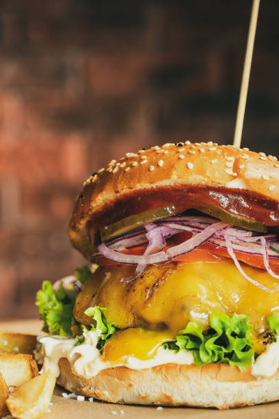 istock Tasty Big Cheese Burger in Sezame Bun with Salad 1303703021