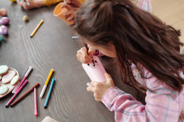 istock Girl making a craft at art class 1303704332