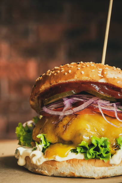 istock Cheese Burger on Wooden Board. Brick Wall Copyspace Background. American BBQ Beef Food 1303704480