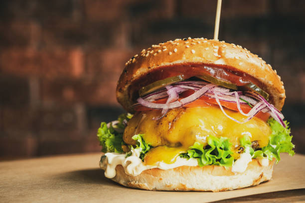 istock Cheese Burger on Wooden Board. Brick Wall Copyspace Background. American BBQ Beef Food 1303704745