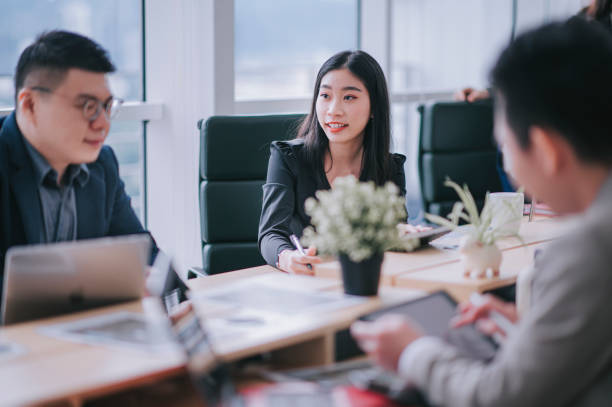 istock Asian chinese business person working in open plan office 1303704762