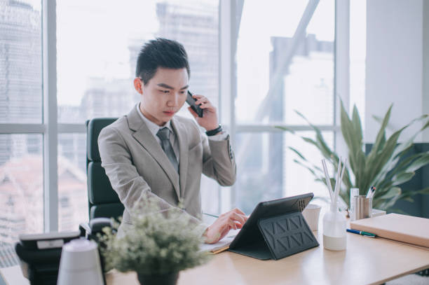 istock asian chinese young executive using digital tablet in his office room serious look 1303704782