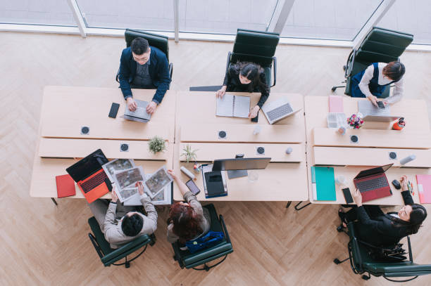 istock directly above Asian chinese business person working in open plan office 1303704800