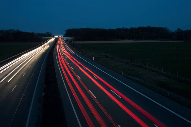 istock Night Autobahn, highway. Light lines from cars. 1303705957