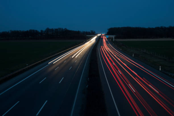 istock Night Autobahn, highway. Light lines from cars. 1303706055