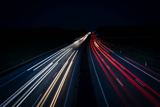 istock Night Autobahn, highway. Light lines from cars. 1303706083