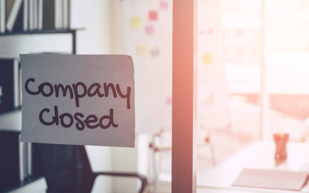 Company closed on windows of an empty office for out of business by economic recession concept. stock photo