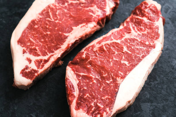 istock Raw New York striploin beef steak isolated on black background 1303708022