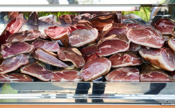 Vacuum packing prosciutto crudo ham at the market stock photo
