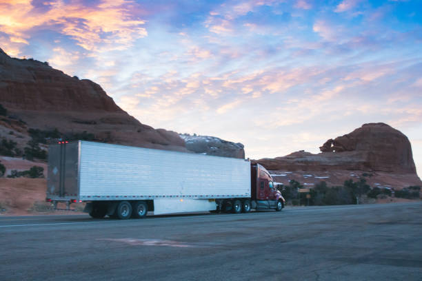 istock Long Haul Semi Trucks on A Two Way Highway 1303709465