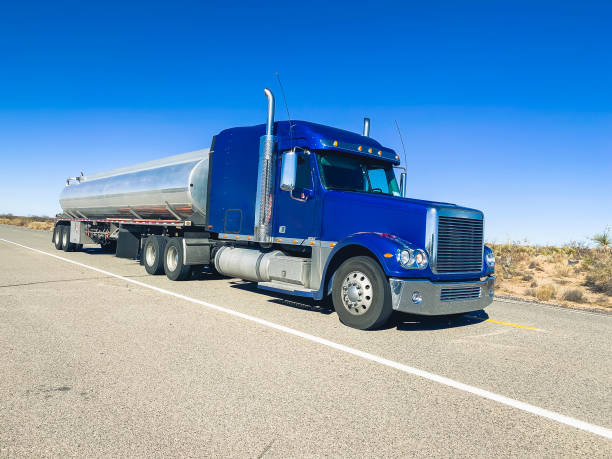 istock Long Haul Semi Trucks on A Two Way Highway 1303709472