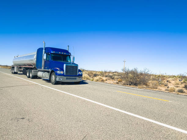 istock Long Haul Semi Trucks on A Two Way Highway 1303709509