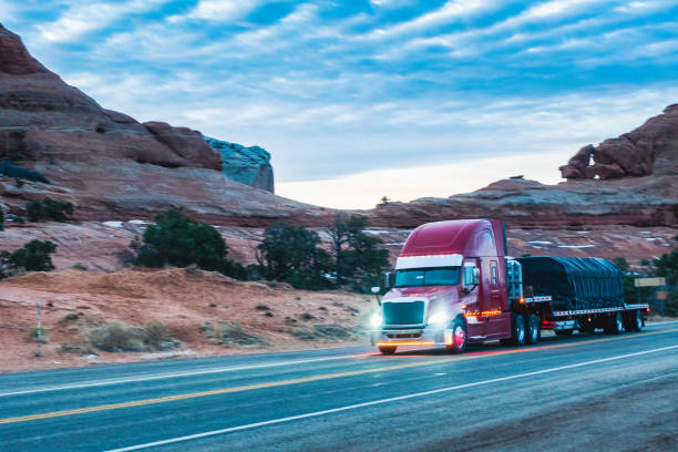 istock Long Haul Semi Trucks on A Two Way Highway 1303709522