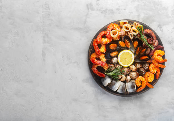 istock Seafood charcuterie board with shrimp, oysters, fish and octopus. Copy space for your text 1303711338