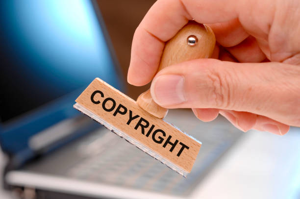 copyright printed on rubber stamp - infringe imagens e fotografias de stock