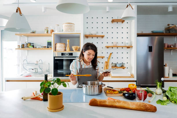 istock Woman cooking, tasting meal 1303712815