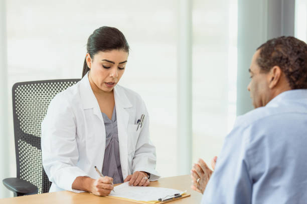 istock Female psychiatrist speaks and takes notes during appointment 1303713831
